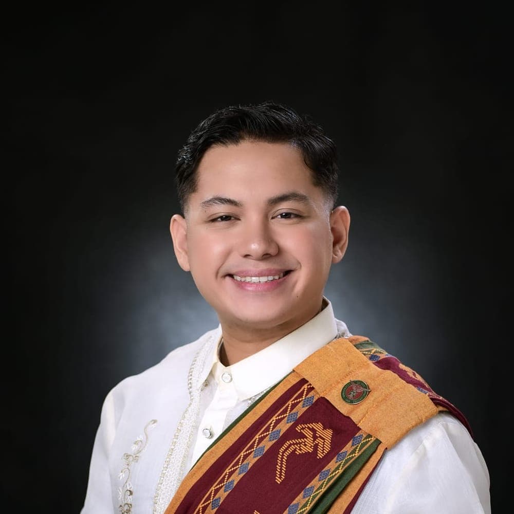 Portrait of Prince Czedrick Nepomuceno wearing his University of the Philippines graduation sash